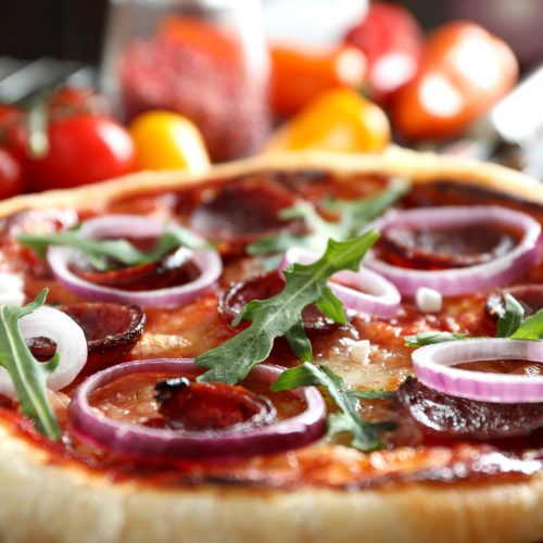 Concept of tasty food with Salami pizza, close up